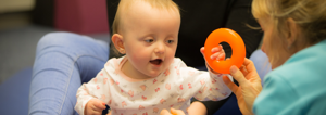 Baby holding plastic ring