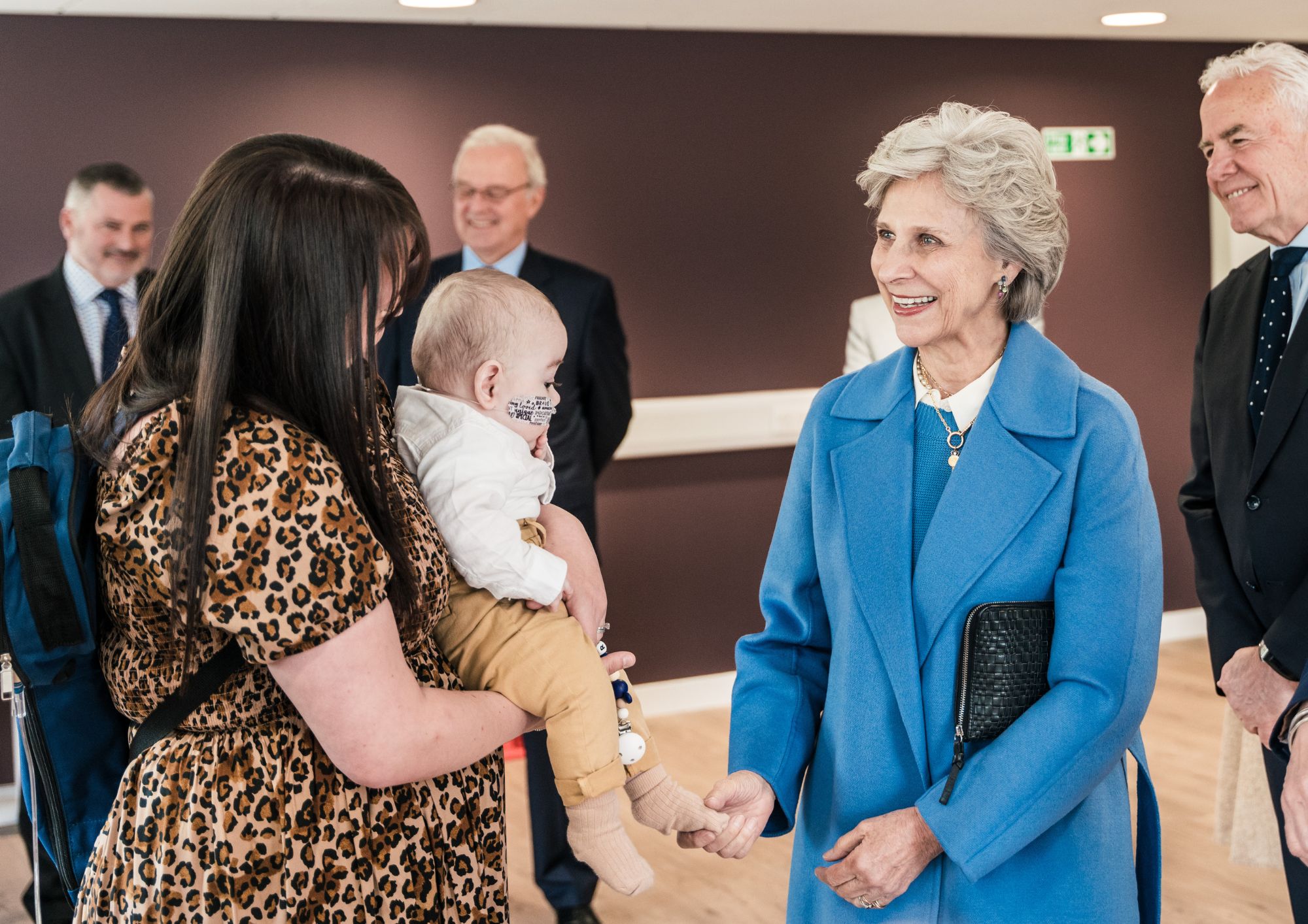 The Duchess of Gloucester meeting a baby