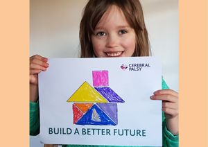 Little girl holding a coloured in picture for the building appeal