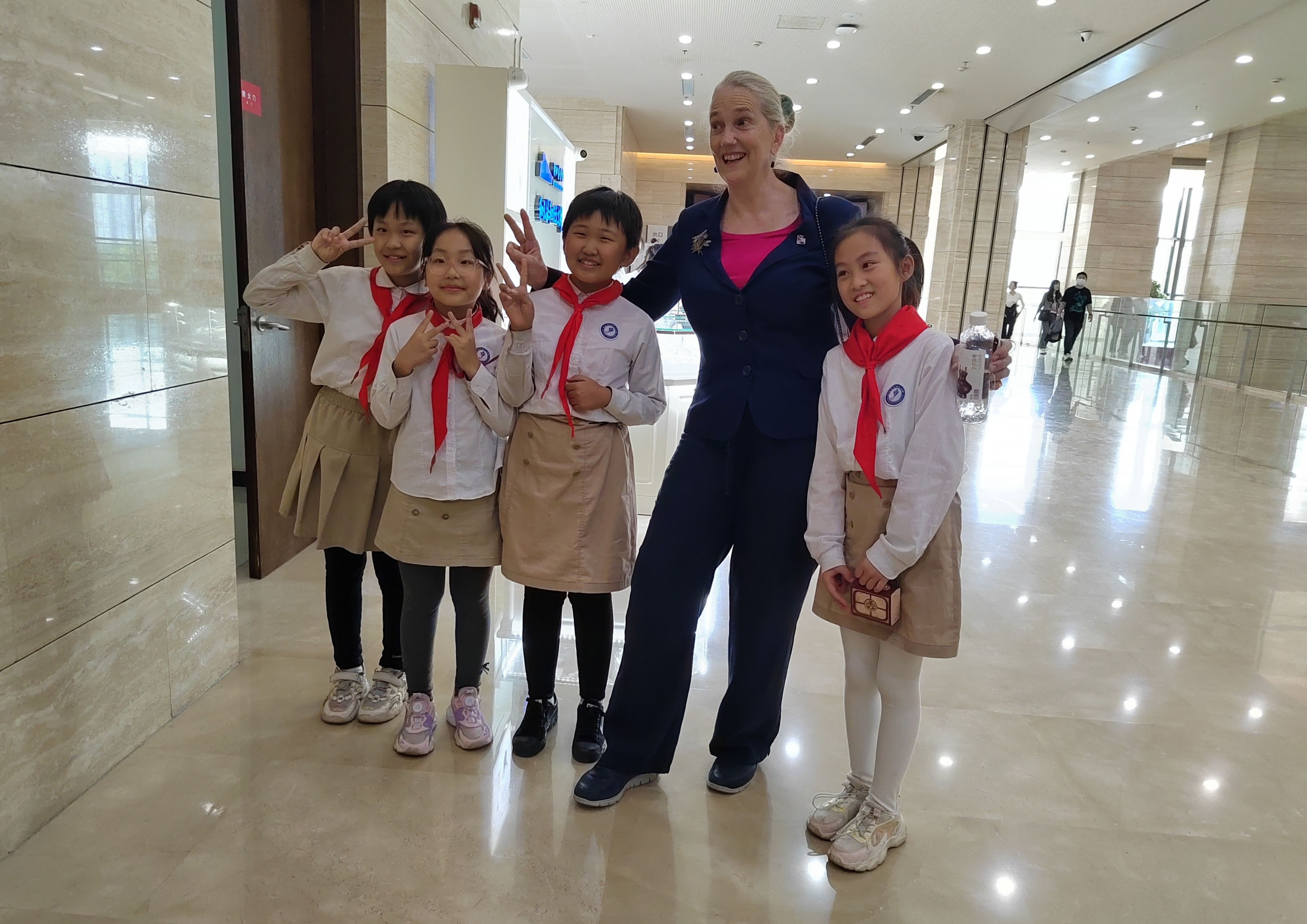 Jenny is photographed with a group of children.