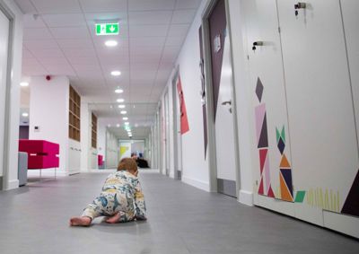 Photograph of baby crawling across floor in our centre.