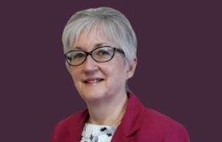 Family Support Officer head shot with purple background.