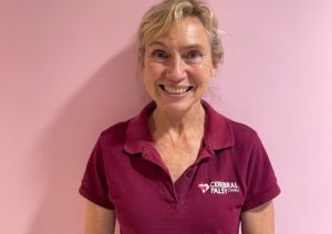 Photograph of our Clinical Expert Physiotherapist in front of pink wall.