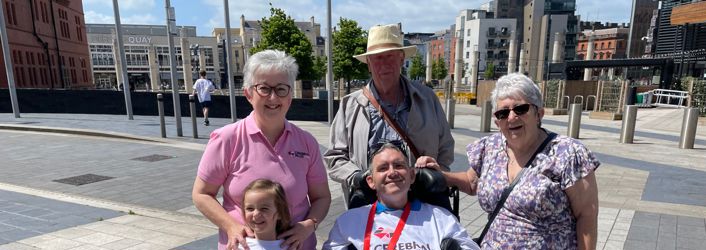 Group photograph of 2 women, 2 men and a child at Cardiff Bay. 