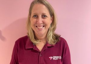 Photograph of one of our occupational therapists in front of pink wall.