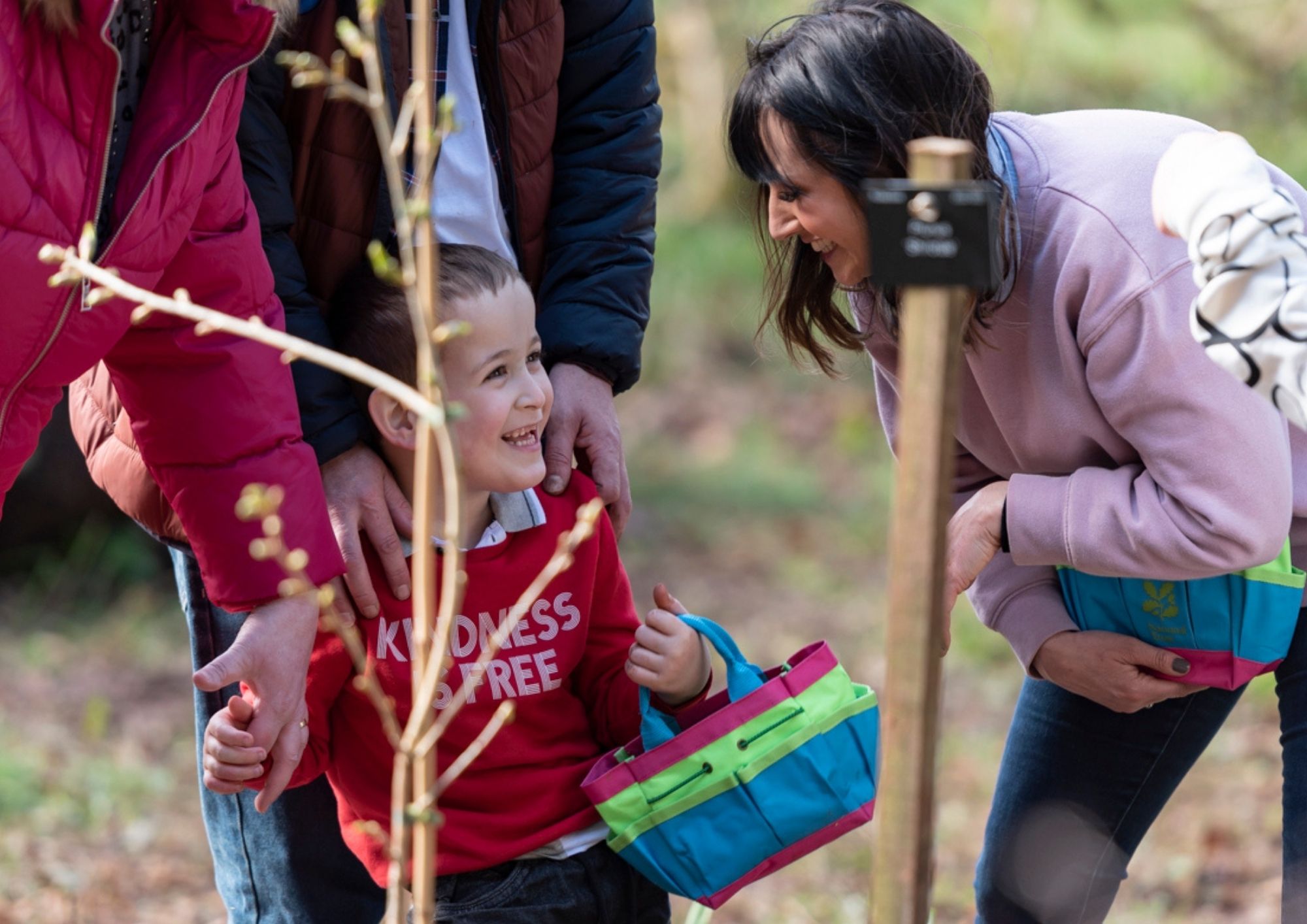 a woman smiling at a young boy