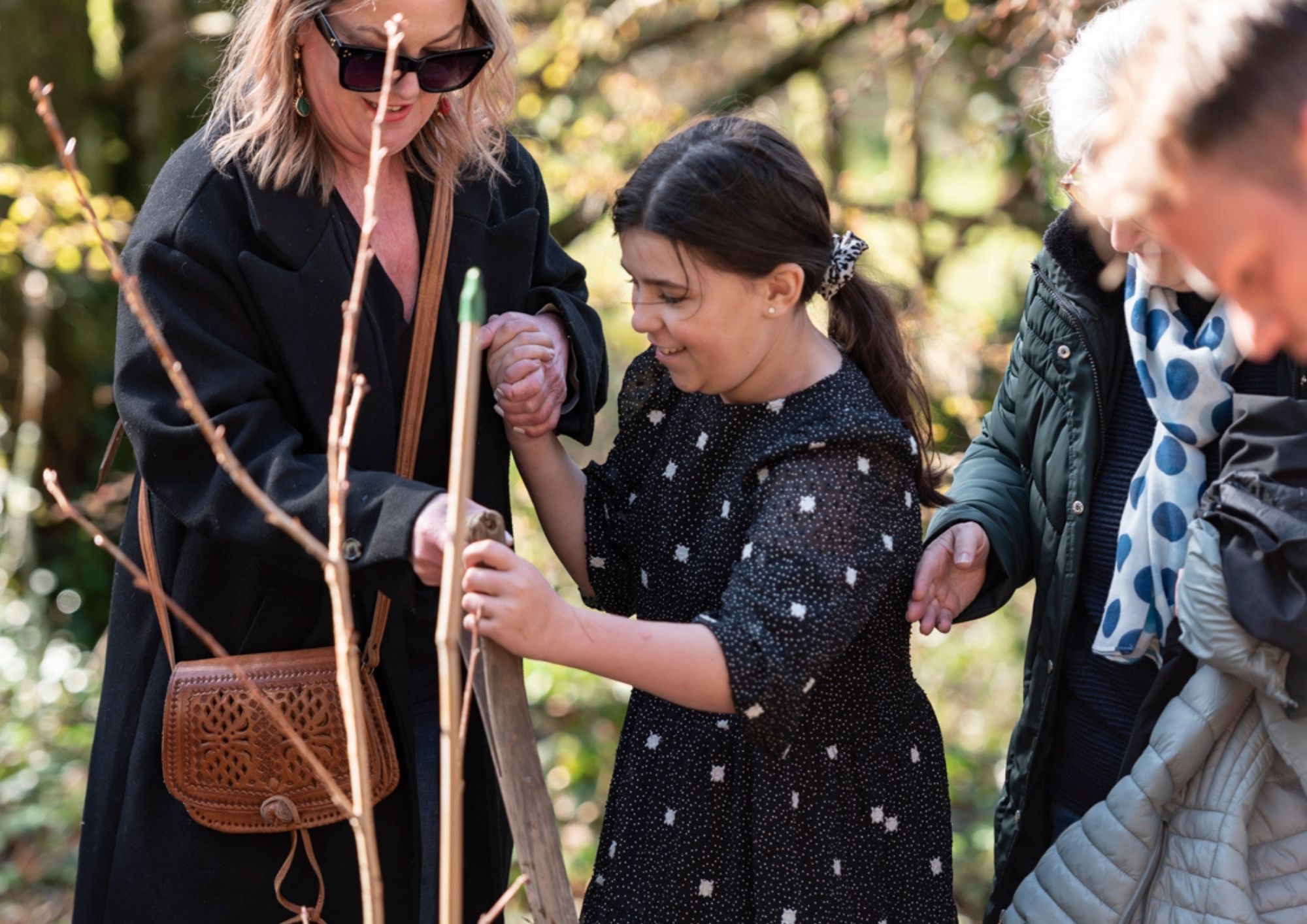 young girl and mum planting a tree