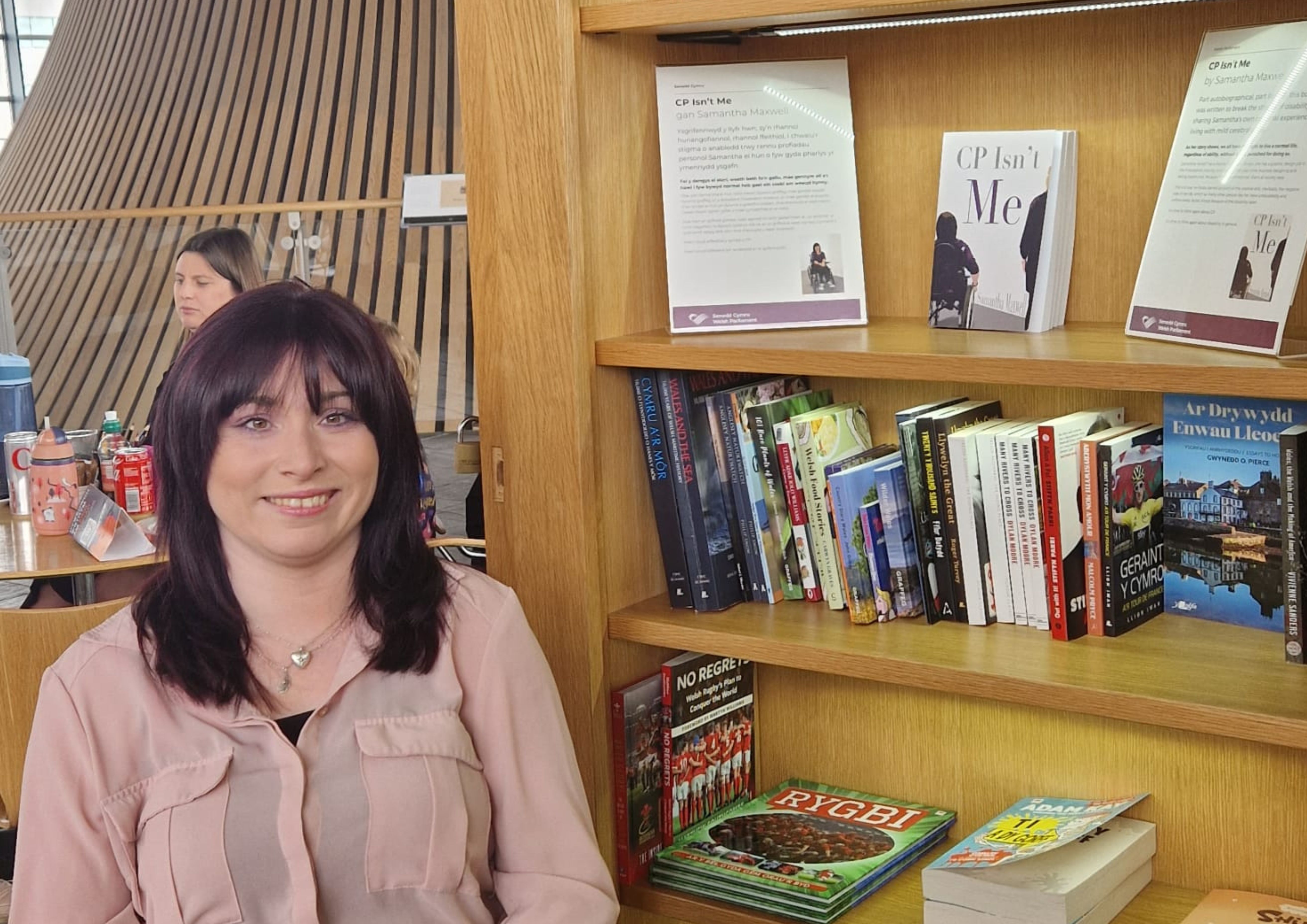 Samantha Maxwell is pictured next to her book display