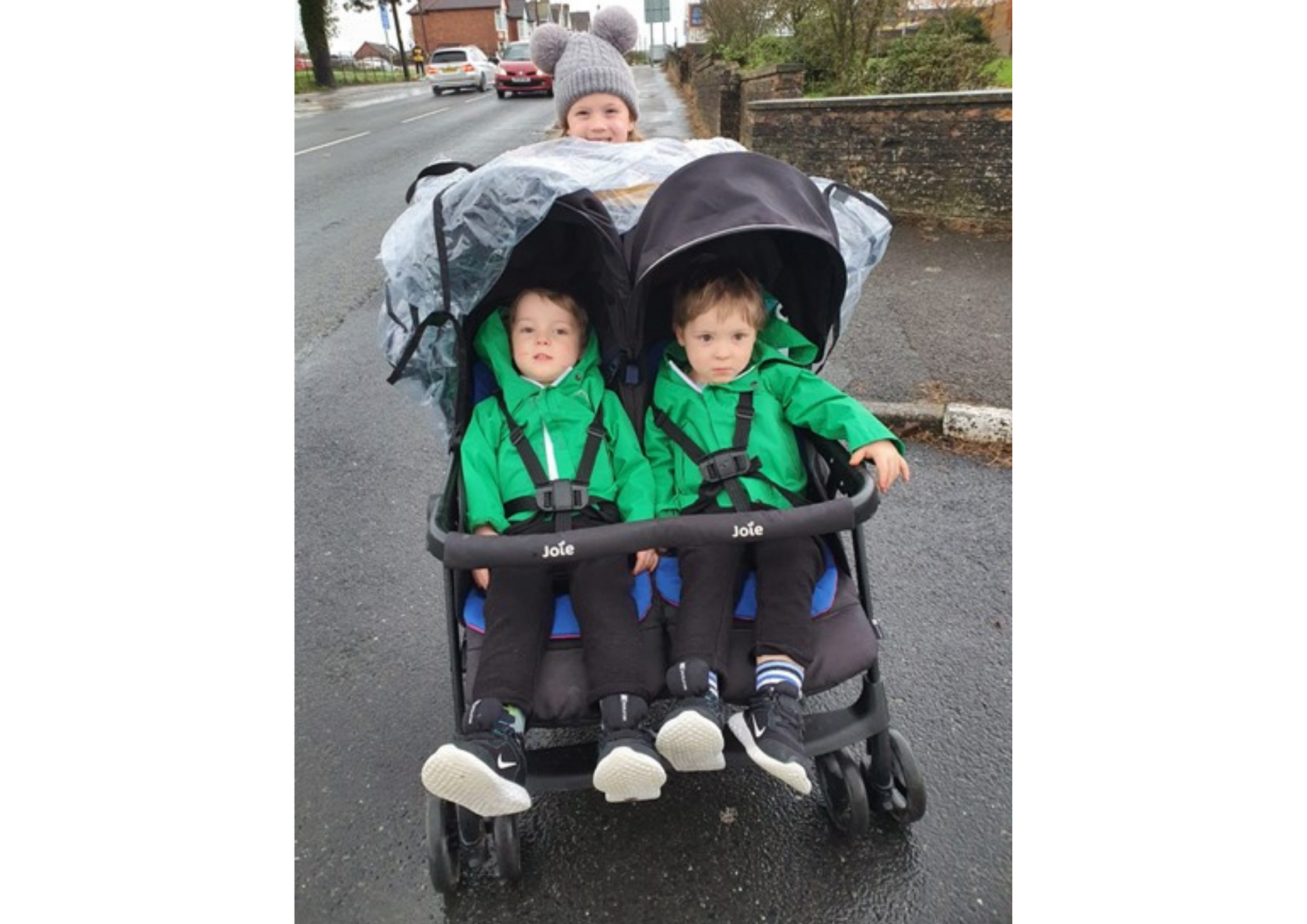 twin boys in push chair with older sister