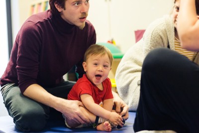 baby smiling with his father