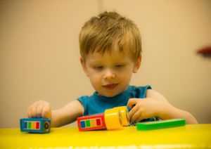 Child Interacting With Toys