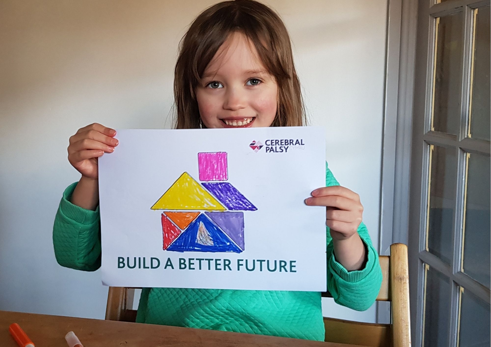 girl holding picture of a house