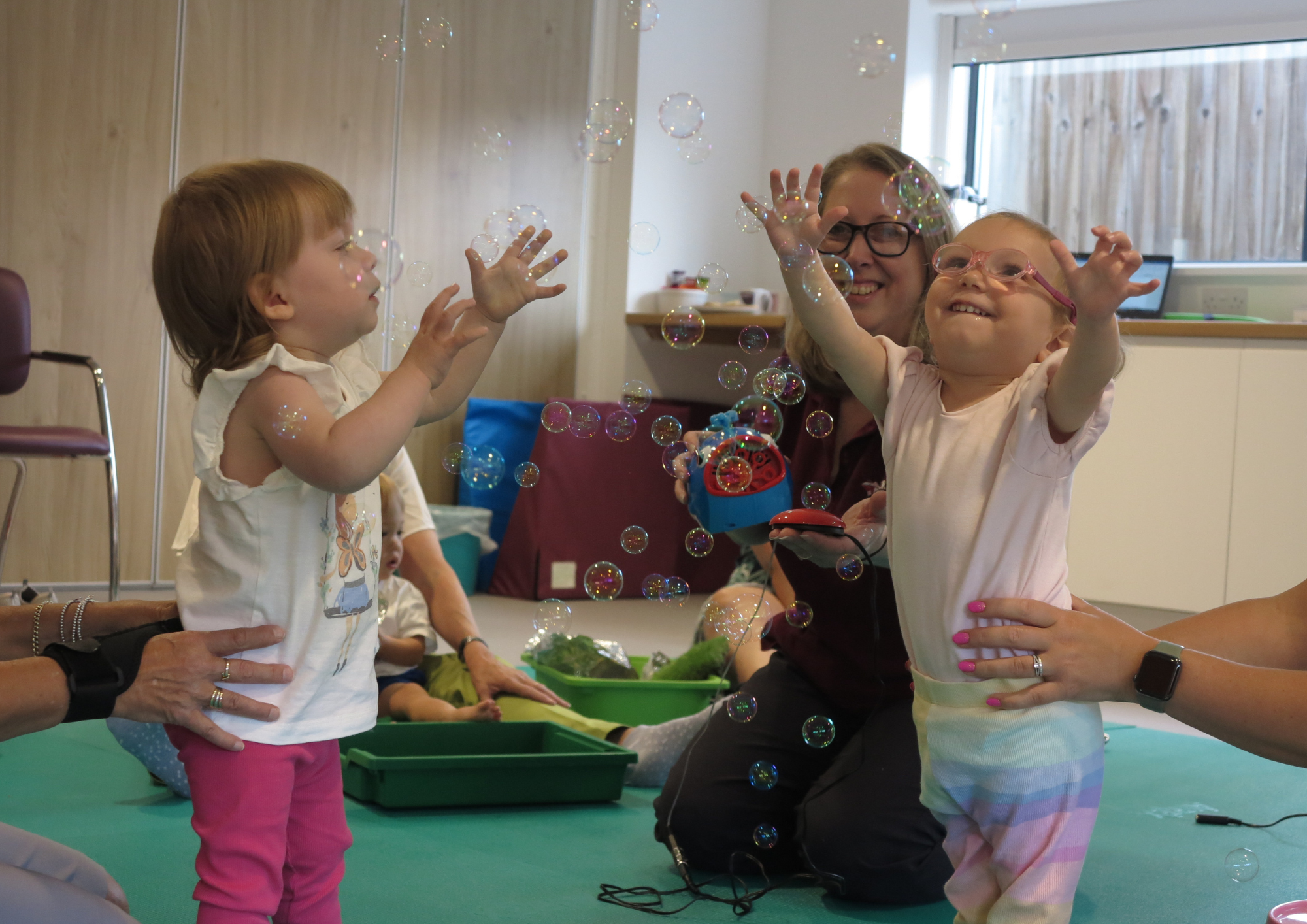 two toddlers playing with bubbles