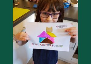 Little girl holding a coloured in picture for the building appeal