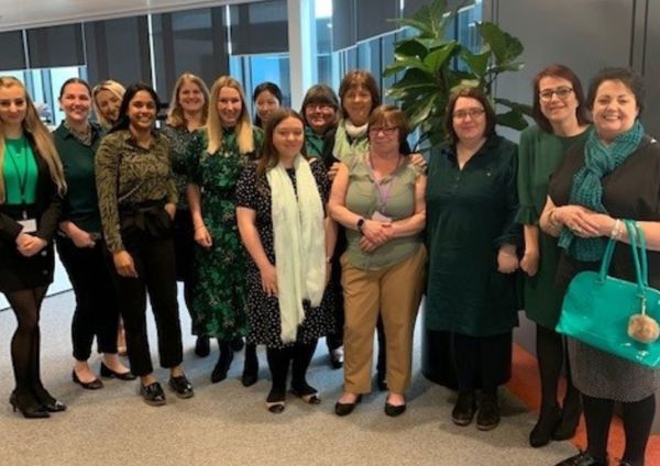 A group photo of people wearing green