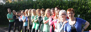 group of staff members stood in a line smiling at the camera