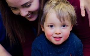 Child looking at camera with mother