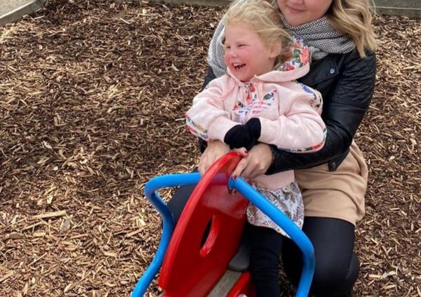 a girl in a park with her mum