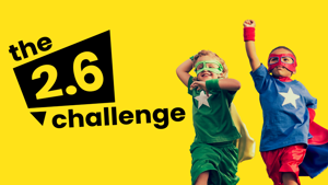 Photograph of 2 young boys dressed as superheroes with yellow background and black text reading the 2.6 challenge.