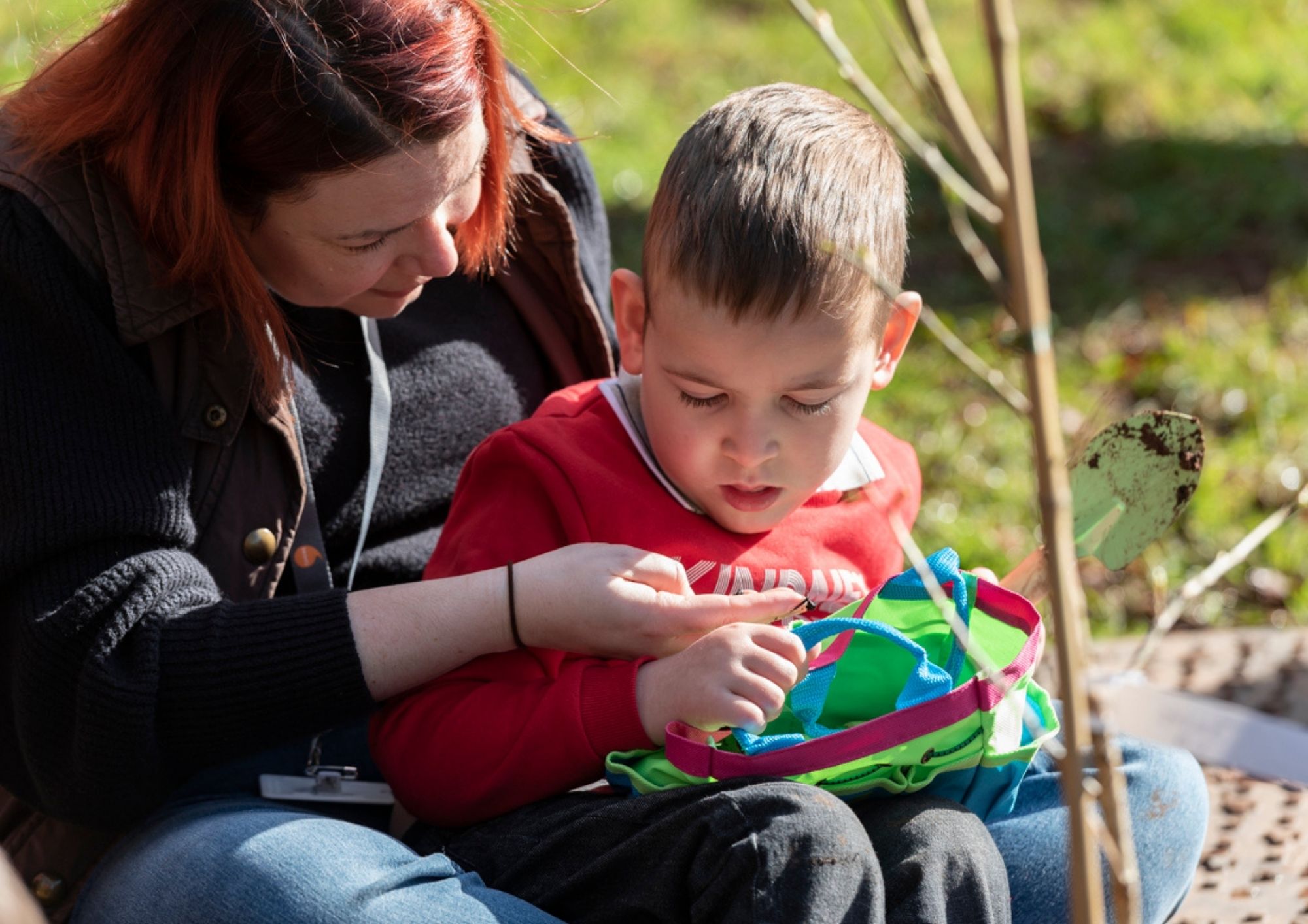 woman with child on lap planting