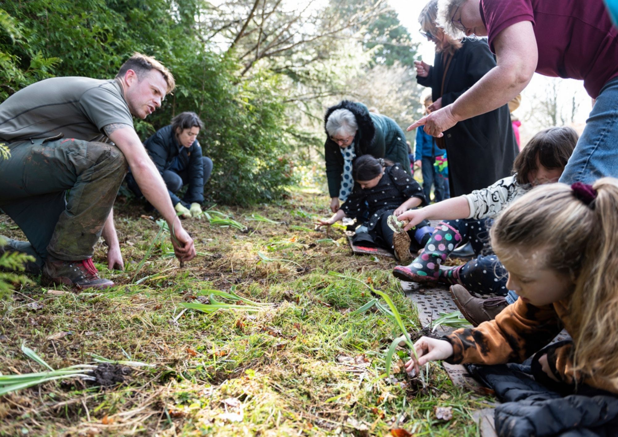 a group of children planting bulbs