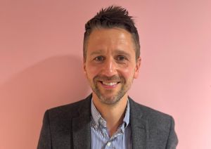 Our Trustee in front of our pink wall.