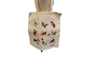 Photograph of Cerebral Palsy Cymru branded tote bag. Canvas with a 9 different tangram shapes on including: bird, butterfly, rabbit, person, fish, horse, dog, cat, person in wheelchair.