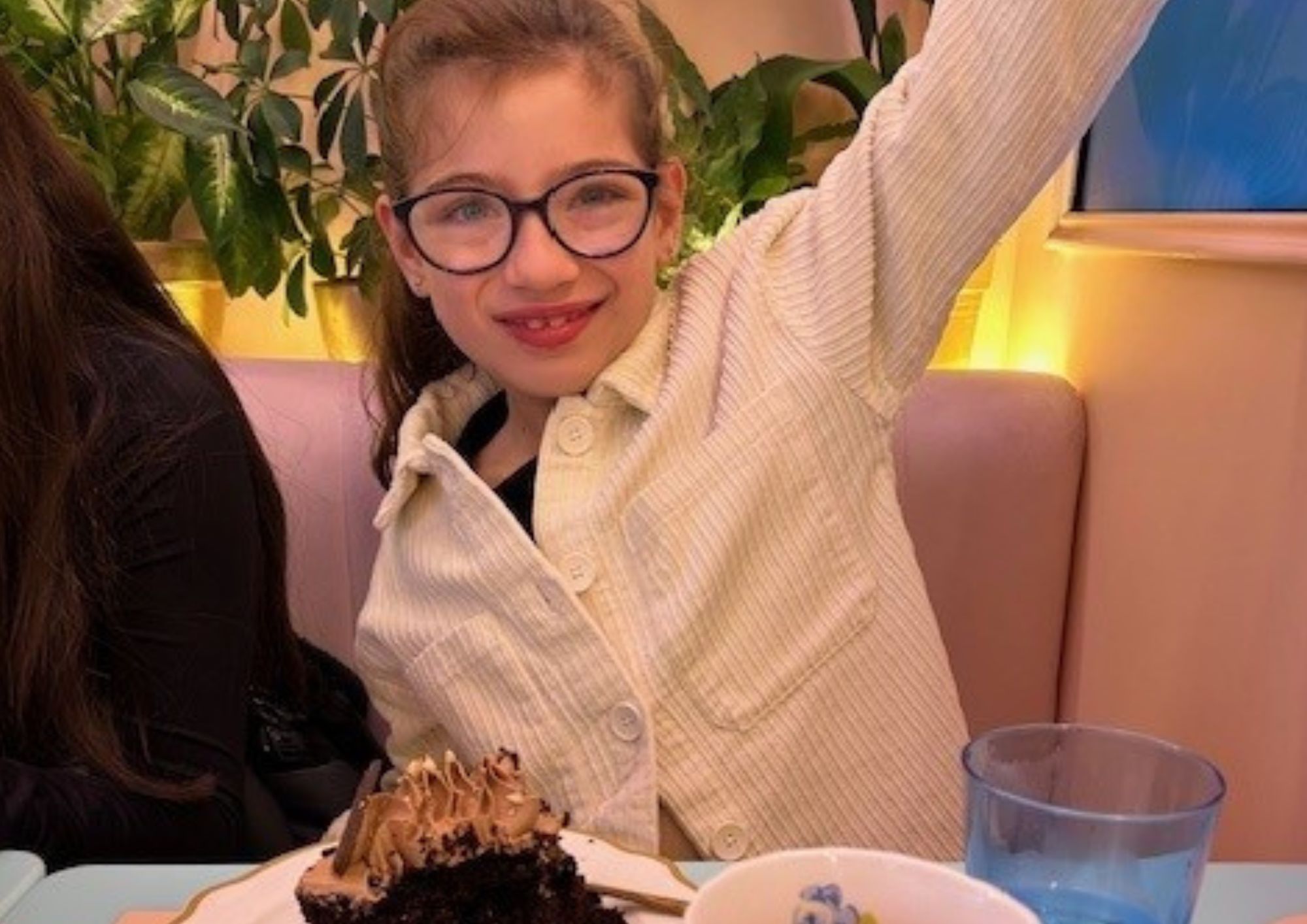 Amelia sitting with a cake in front of her.