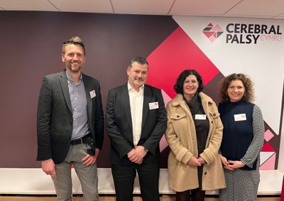 Photograph of our new trustees standing in front of our branded wall in our centre. From left to right, Toby Jones, Jason Llewellyn,Vicky Stevenson, Lisa Tregale.