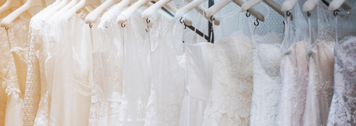 Photograph of wedding dresses hanging up. 