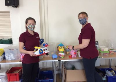 Photograph of therapists, Helen and Kirsty, in masks holding toys.