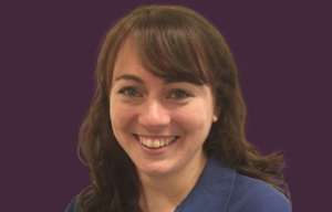 Therapist head shot with purple background.
