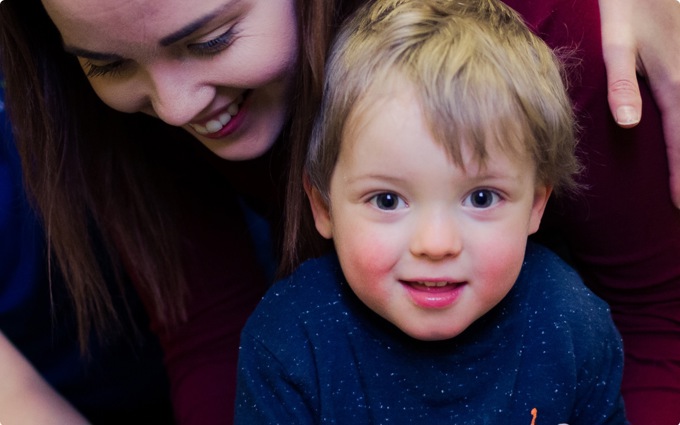 Child looking at camera with mother